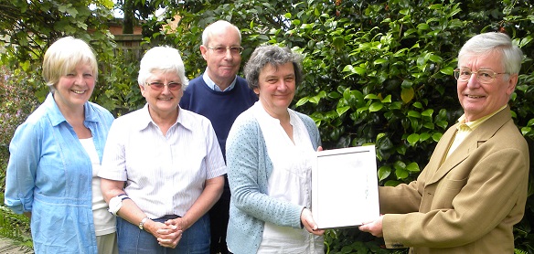 The certificate for "Best Website for Small Societies for 2014" is presented to the members who created the website.