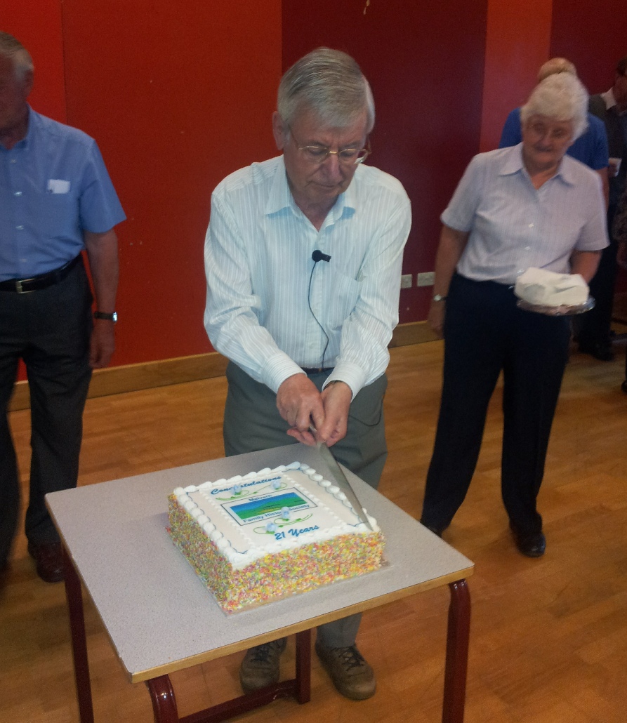 Frank Townsend cutting MFHS 21st birthday cake